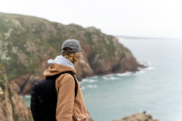 Traveler woman contemplating the panoramic views from the cliffs.