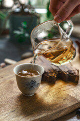 Pouring tea traditionally creates a unique ambiance and soothing aroma for a delightful experience