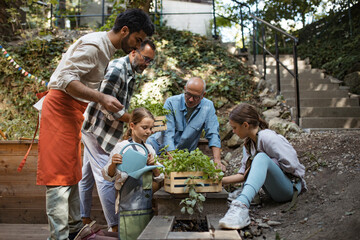 Volunteers at neighbourhood project planting herbs in community garden