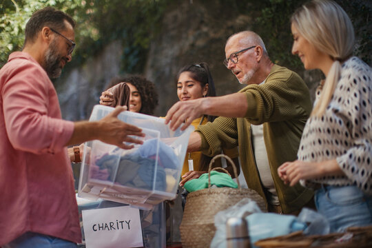 People donating and collecting clothes for charity