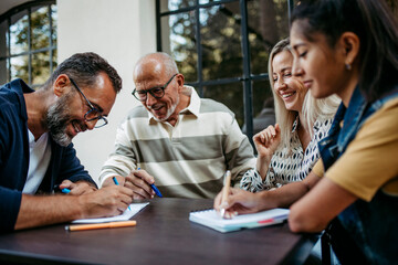 Group of committed people having meeting in front of community building
