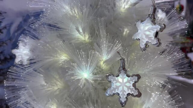 4k footage close up of lighted Christmas tree ornaments and decorations. Mistletoe, baubles, and bell with Interactive sparkling christmas twinkle lights or icicle lights.