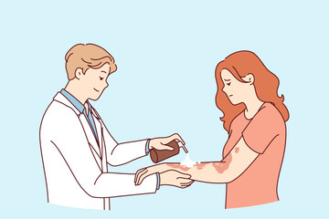 Dermatologist treats eczema on hands of woman suffering from skin disease and pigmentation spots. Man doctor in white coat uses spray for eczema, applied medicinal ointment to body of upset girl
