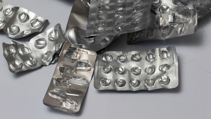 A pile of broken pills on a white surface