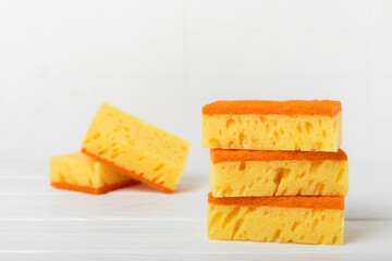 Colorful dish sponges on textured background. Kitchen sponge. Cleaning concept, cleaning service. Dishwashing liquid with clean and dirty dishes plate. Place for text, copy space. Wash the dishes.