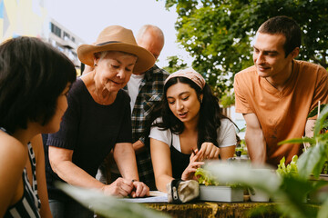 Small group of people discussing urban gardening in green city.