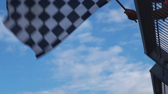 Man waving checkered flag at finnish