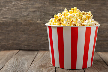Popcorn box. Red and white striped buckets of salted popcorn on a colored background. Cinema and...