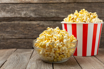 Popcorn box. Red and white striped buckets of salted popcorn on a colored background. Cinema and...