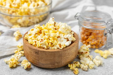 Salty popcorn on bright color background. Cinema and entertainment concept. Movie night with popcorn. Delicious appetizer, snack.Space for text, copy space. Banner