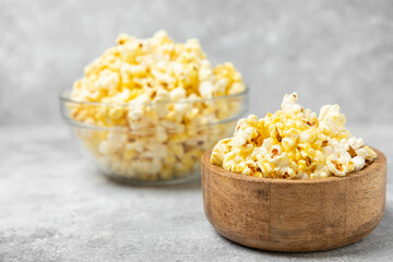 Salty popcorn on bright color background. Cinema and entertainment concept. Movie night with...