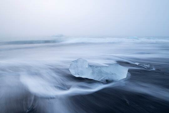 Piece of ice on the black sand beach of Diamond Beach near J�kuls�rl�n glacier lagoon in Vatnaj�kull National Park, Iceland.