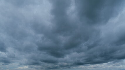 Obraz premium Gray cumulus rain dark clouds panoramic view. Massive dark rain storm clouds bg for weather forecast. Timelapse.