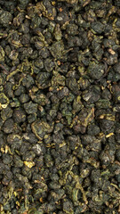 Closeup view showcasing the intricate details of Dried Green Tea Leaves in a vivid manner