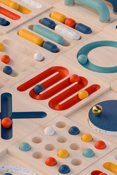 Colorful abstract wooden game pieces arranged in a geometric pattern