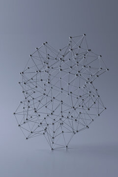 Abstract network of connected metal dots on a gray background.