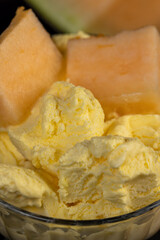 sweet creamy ice cream and pieces of melon on the table