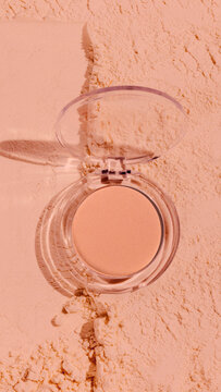 Compact powder foundation product shot on nude textured background