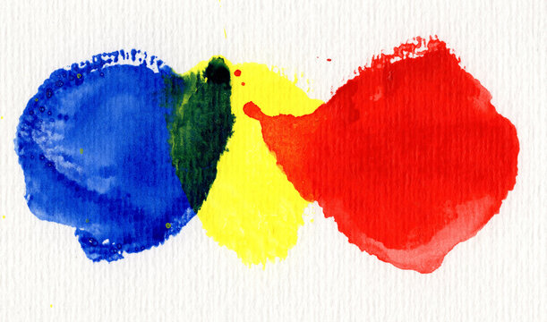 Abstract watercolor painting with overlapping primary colors on paper