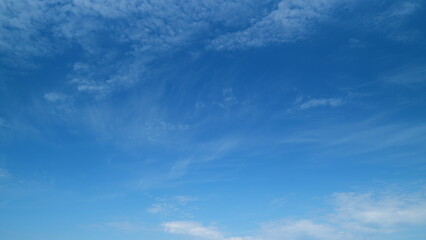 Sky with several layers of clouds moving in different directions. Sun rays at sunshine day. Timelapse.