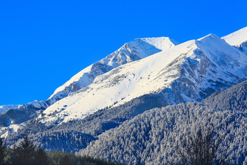 Snow mountains peaks and blue sky