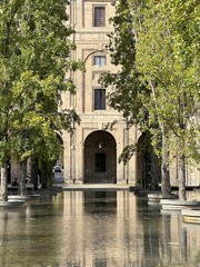 Palazzo della Pilotta reflected in the water of the fountain in the historical centre of Parma, Emilia-Romagna, Italy, October 2023