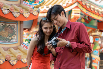 Celebrating chinese new year a young couple captures joyful moments at a colorful festival outdoor setting candid