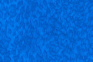 Blue color velour or velvet with short pile fluffy and soft texture background. Close-up image of lapis colour surface level fabric material, azure colored background texture of cloth, copy space