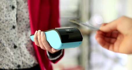 A customer smoothly making a payment with a contactless card to a sales associate through a handheld payment device - Powered by Adobe