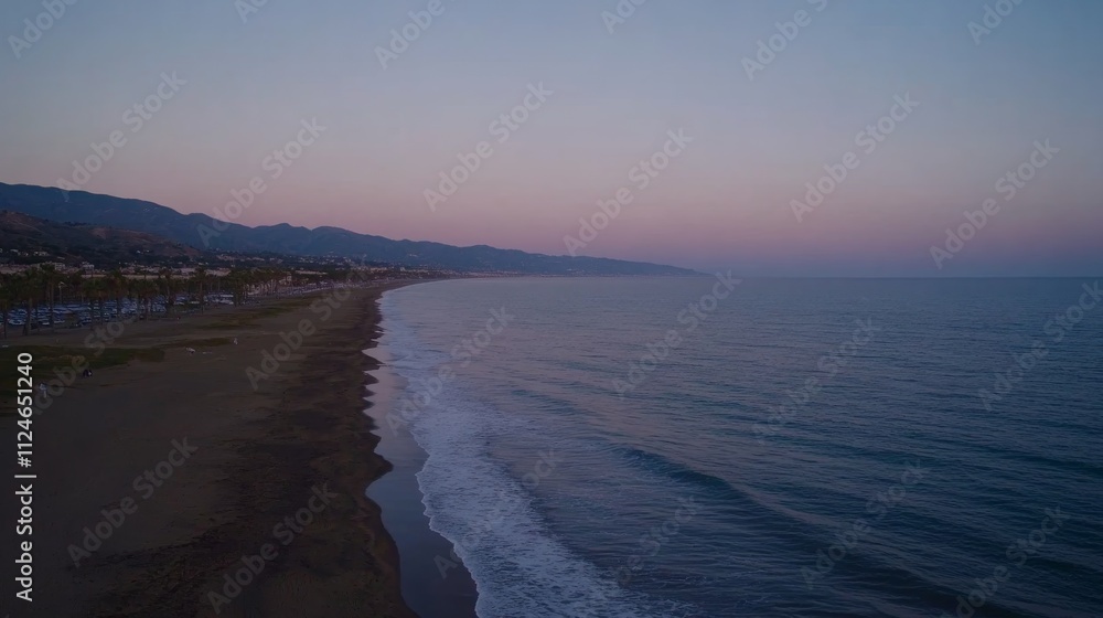 Poster a tranquil beach view captures the merging pink and blue hues of twilight as soft waves gently lap a