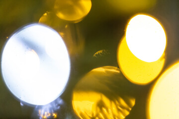 In the dim night, there is a blurry picture showcasing a cluster of colorful lights flickering in...