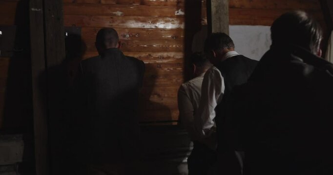 A man gets ordered at gunpoint to tie up two other man who have surrendered to an undercover detective