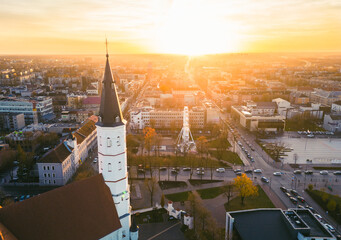 Aerial panorama Siauliai sun city in Lithuania in sunny autumn day on sunset with cityscape and...