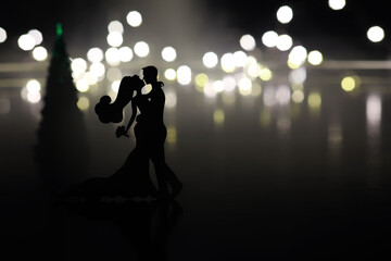 Black silhouettes of pair dancers performing. Man and woman are dancing on gray background with...
