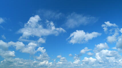Soft white clouds. Clouds form against a dark blue sky. Blue sky white clouds. Time lapse.