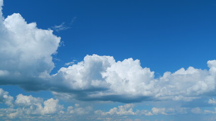 Dark blue sky with clouds. Fluffy white clouds to dark rain clouds. Moving and changing cloudscape weather. Time lapse.