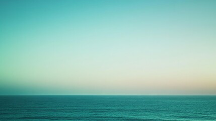 Fototapeta premium A soft, blurred image of the ocean and sky at sunset in pastel colors.