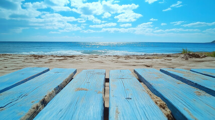 Fototapeta premium Serene Beach Scene with Blue Wooden Platform. A tranquil beach scene featuring light blue weathered wooden planks positioned on the sand, leading the eye to the vast expanse of a shimmering blue ocean