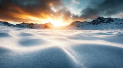 Obraz premium A breathtaking snowy landscape featuring pristine white snow dunes stretching into the distance, framed by rugged mountains silhouetted against a sunset sky.