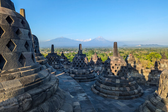 Borobudur Temple Stupas at Sunset with Mt. Merapi, Java, Indonesia