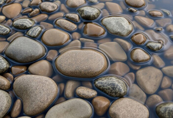 Smooth River Stones Shaped By Flowing Water