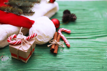 Christmas composition of fir branches and Christmas toys. Santa hat with gifts, horizontal position...
