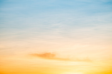 Obraz premium Sky,sunset, beautiful , luxury soft gradient orange gold clouds and sunlight on the blue sky perfect for the background, Sunrise on morning or everning in winter warm time ,Twilight summer,silhouette