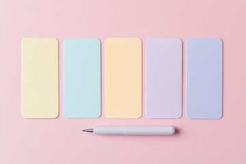 Colorful pastel sticky notes arranged on a light pink background with a white pen nearby