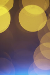Abstract bokeh background. Golden bokeh circles on dark blue background. Layer overlay.
