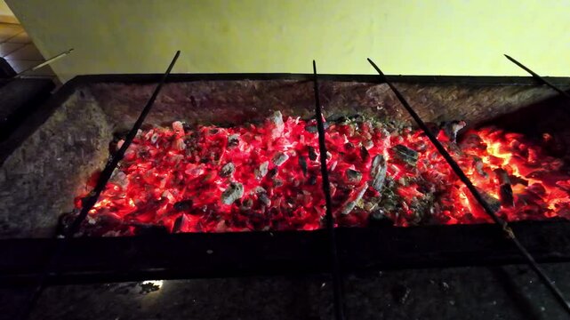 Stainless steel skewers heating up on coal barbeque in Sharm el Sheikh, Egypt.