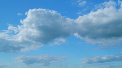 Dramatic Summer cloudscape. Blue sky white clouds. Changing cloudscape. Time lapse.