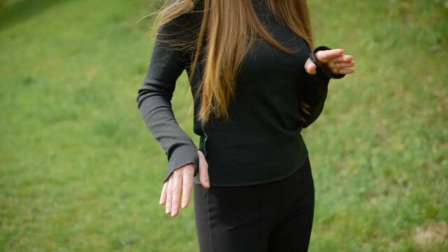 Woman energetically moving hips and arms during lively dance. Female shaking hips and waving arms passionately while dancing. Lady vigorously swaying waist and gesturing hands in exciting dance