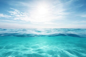 Obraz premium Bright sunlight shines over calm turquoise ocean waters during a clear day