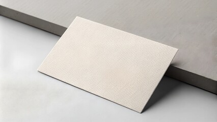 Textured business card mockup on a neutral background with soft shadows